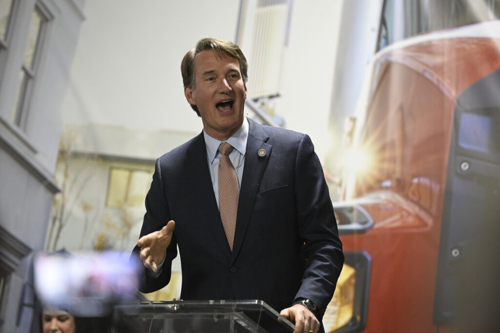 Virginia Governor Glenn Youngkin at a podium addressing people at an event.