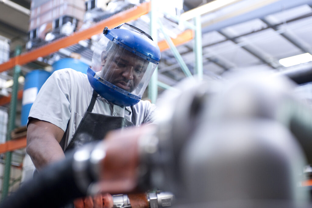 Black man wearing personal protective equipment works at QualiChem in Salem, Virginia.